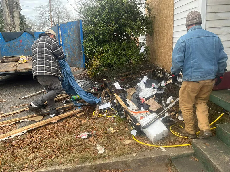 Hoarder cleanout debris and clutter outside a property