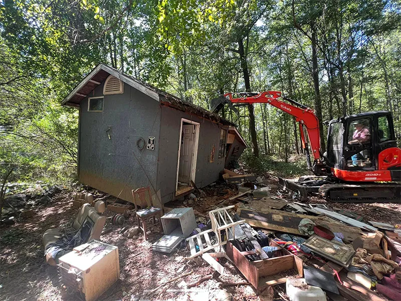 Light demolition of a shed with excavator